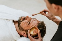 Man getting spa facial mask, self-care photo