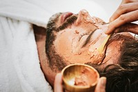 Man getting spa facial mask, self-care photo