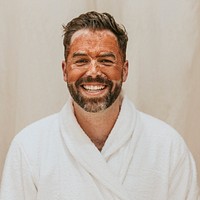 Man in bathrobe with facial mask 