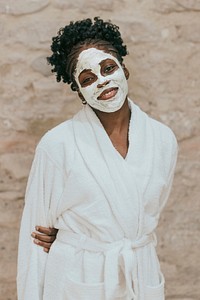 African American woman with mud facial mask on her face
