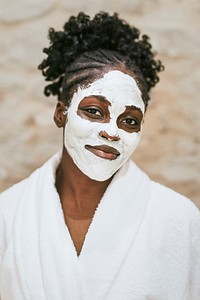 African American woman with mud facial mask on her face