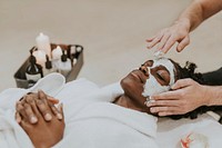 Woman getting spa face mask, relaxation photo