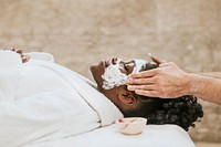 Woman getting spa face mask, relaxation photo