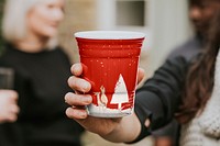 Cup mockup psd being hold by a person for toasting 