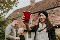 Happy friends toasting to celebrate at a Christmas party