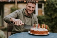 Man slicing a piece of cake at a birthday party 