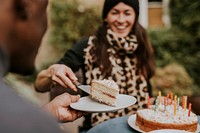 Woman distributing pieces of cake at a birthday party