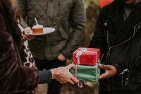 Friends exchanging gifts at a Christmas party 