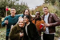 Friends with drinks in hand posing for a group photo 