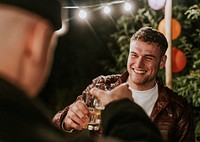 Happy male friends toasting to celebrate at a Christmas party