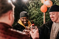 Happy male friends toasting to celebrate at a Christmas party