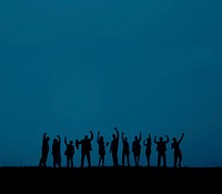 silhouette of business people with arms raised