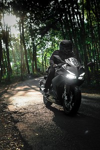 Man on a motorbike in a forest in Indonesia
