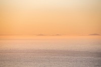 Foggy and faint ocean horizon at sunset