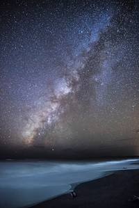 The Milky Way crossing the night sky at Waimea State Recreation Pier in Hawaii, USA