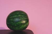 Whole watermelon on pink background