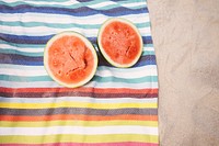 Two watermelon halves on the beach