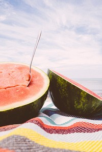 Two watermelon halves on the beach
