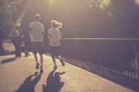 People jogging over a bridge