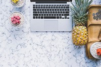 Pineapple next to a laptop