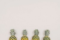 Four ripe pineapples aligned together