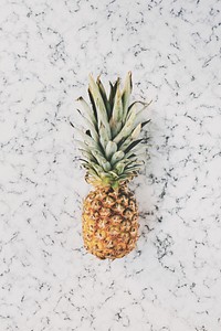 Ripe pineapple on a marble slate
