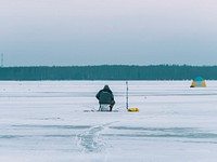 Man fishing on a frozen lake in Mozhaysk, Russia<br />