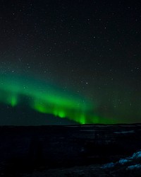 Hills covered with snow and northern lights