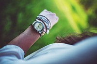 Woman checking her watch. Visit <a href="https://kaboompics.com/" target="_blank">Kaboompics</a> for more free images.