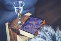 Wine glass and a book. Visit <a href="https://kaboompics.com/" target="_blank">Kaboompics</a> for more free images.