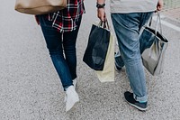 Couple walking with shopping bags. Visit <a href="https://kaboompics.com/" target="_blank">Kaboompics</a> for more free images.