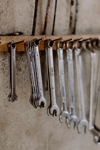 Row of wrenches hanging on a wall. Visit <a href="https://kaboompics.com/" target="_blank">Kaboompics</a> for more free images.