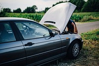 Man fixing a car engine. Visit <a href="https://kaboompics.com/" target="_blank">Kaboompics</a> for more free images.