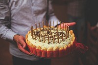 Man holding a birthday cake. Visit Kaboompics for more free images.