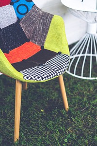 Colorful chair on green grass. Visit <a href="https://kaboompics.com/" target="_blank">Kaboompics</a> for more free images.