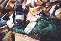 Lantern on a stack of firewood. Visit <a href="https://kaboompics.com/" target="_blank">Kaboompics</a> for more free images.