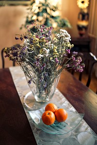 Oranges and flowers on a table. Visit Kaboompics for more free images.