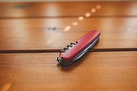 Swiss army knife on a table. Visit Kaboompics for more free images.