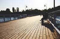 Men sitting at a wooden pier. Visit <a href="https://kaboompics.com/" target="_blank">Kaboompics</a> for more free images.