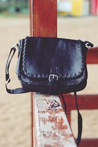 Black leather bag with a strap. Visit Kaboompics for more free images.