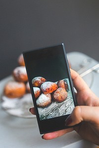 Woman taking a photo of pastries. Visit <a href="https://kaboompics.com/" target="_blank">Kaboompics</a> for more free images.