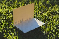 Notebook in the grass. Visit <a href="https://kaboompics.com/" target="_blank">Kaboompics</a> for more free images.