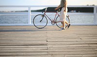 Man walking with a bicycle. Visit <a href="https://kaboompics.com/" target="_blank">Kaboompics</a> for more free images.