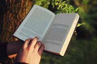 Man reading a book outdoors. Visit Kaboompics for more free images.