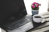 Cup of coffee and flowers on a table. Visit Kaboompics for more free images.