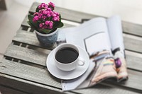Cup of coffee and flowers on a table. Visit <a href="https://kaboompics.com/" target="_blank">Kaboompics</a> for more free images.