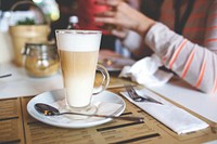 Woman having a latte coffee. Visit <a href="https://kaboompics.com/" target="_blank">Kaboompics</a> for more free images.