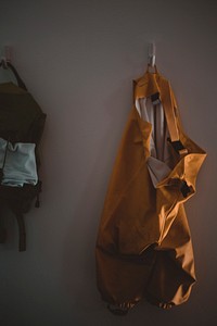 Orange construction clothing hanging on the wall
