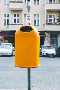Yellow trash bin by the street
