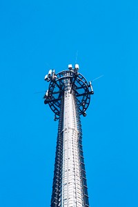 Transmission cellular tower against the blue sky